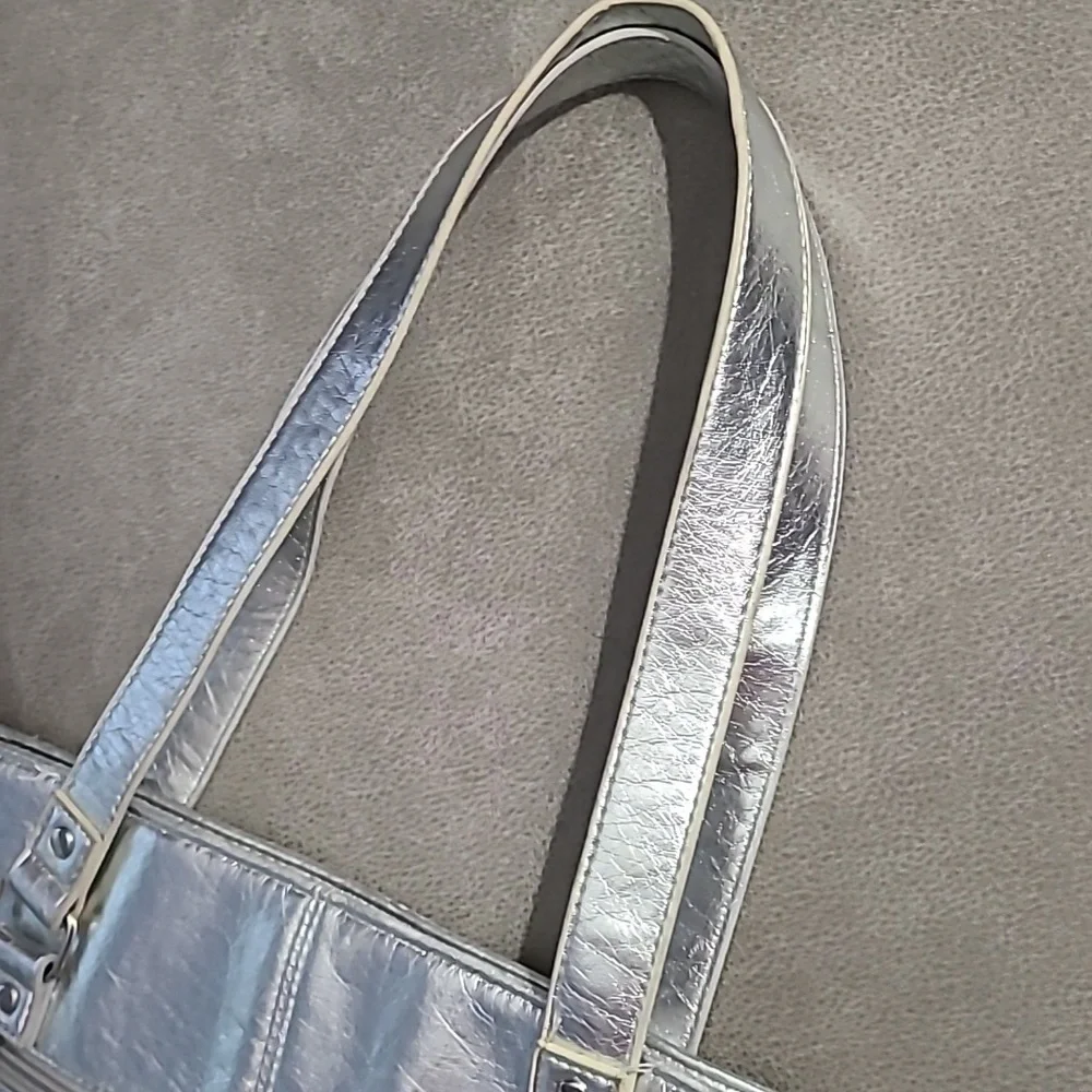 Shiny silver metallic handbag. Outside pockets snap closure‎ clean inside